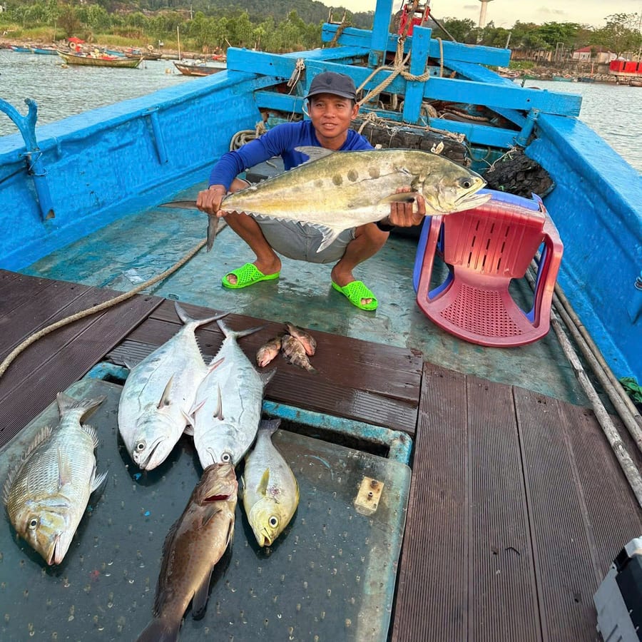 Local crew member on deck with the day catch off Nha Trang