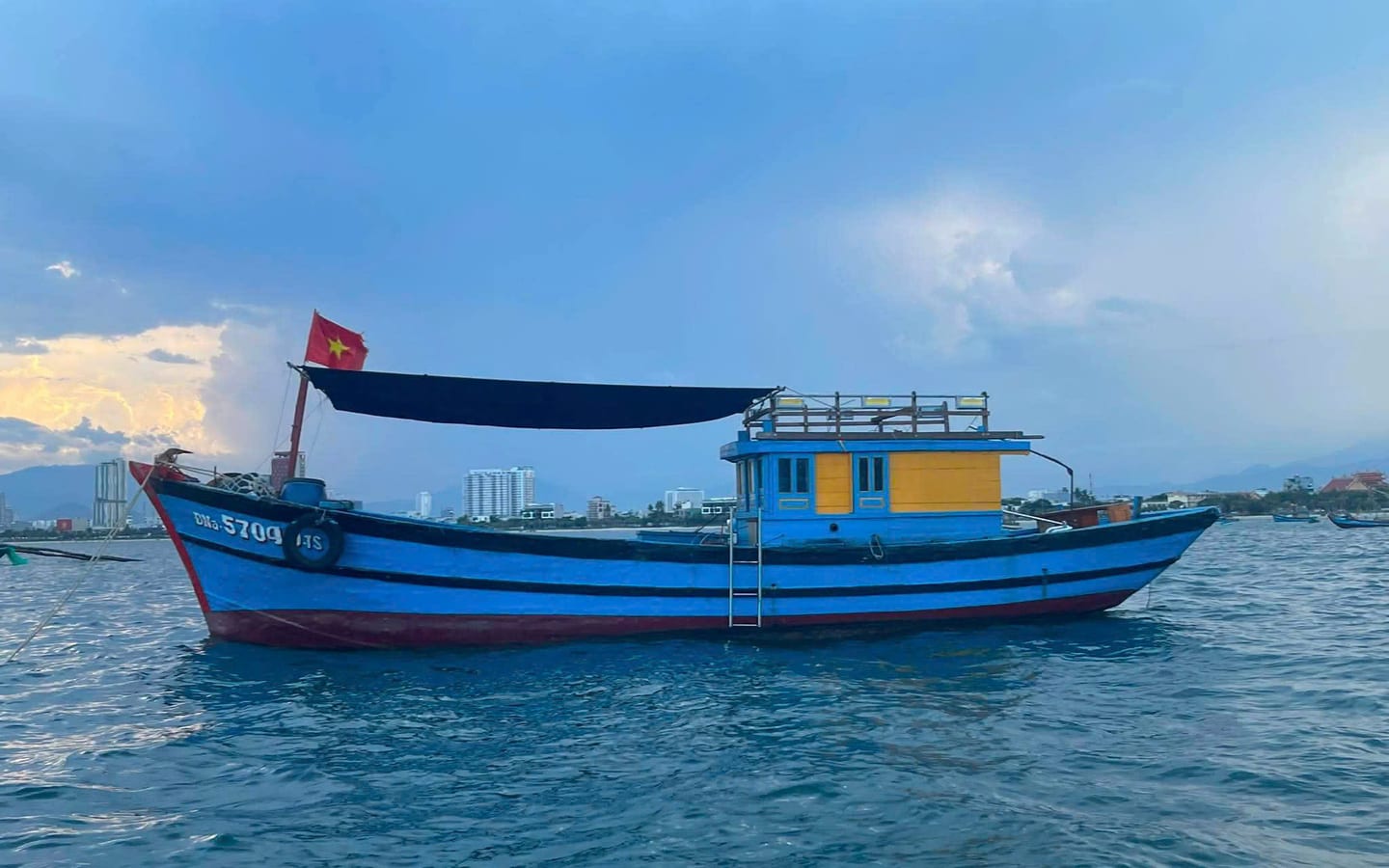Traditional blue wooden fishing boat used for Nha Trang fishing tours